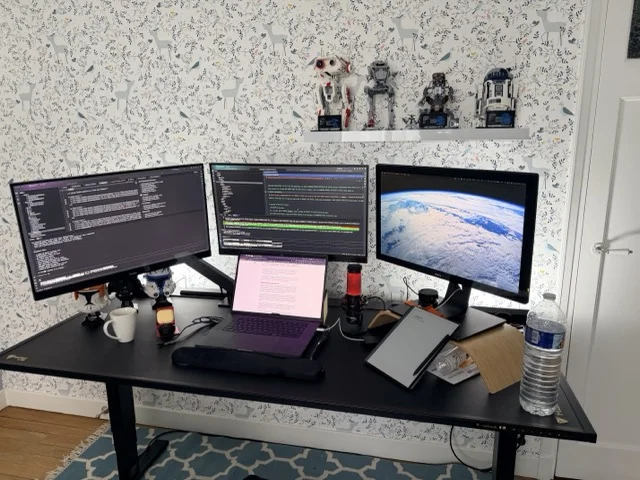 Multi-screen builder setup with code editors, terminals, and AI agents running simultaneously